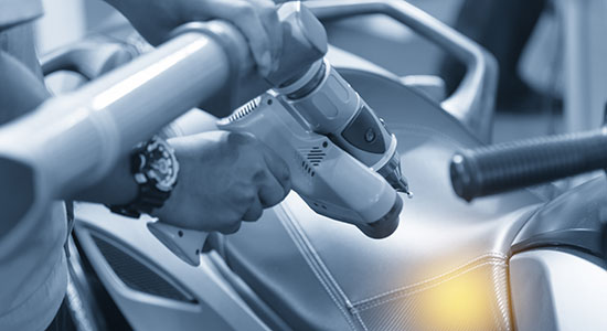 Robotic arm with a 3D measurement sensor inspects vehicle surfaces using laser triangulation in automotive production